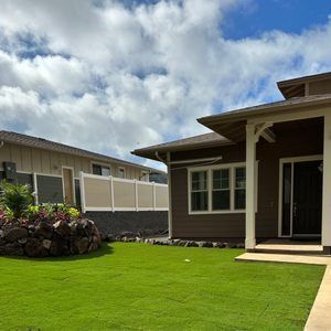 A house with a large lawn in front of it.