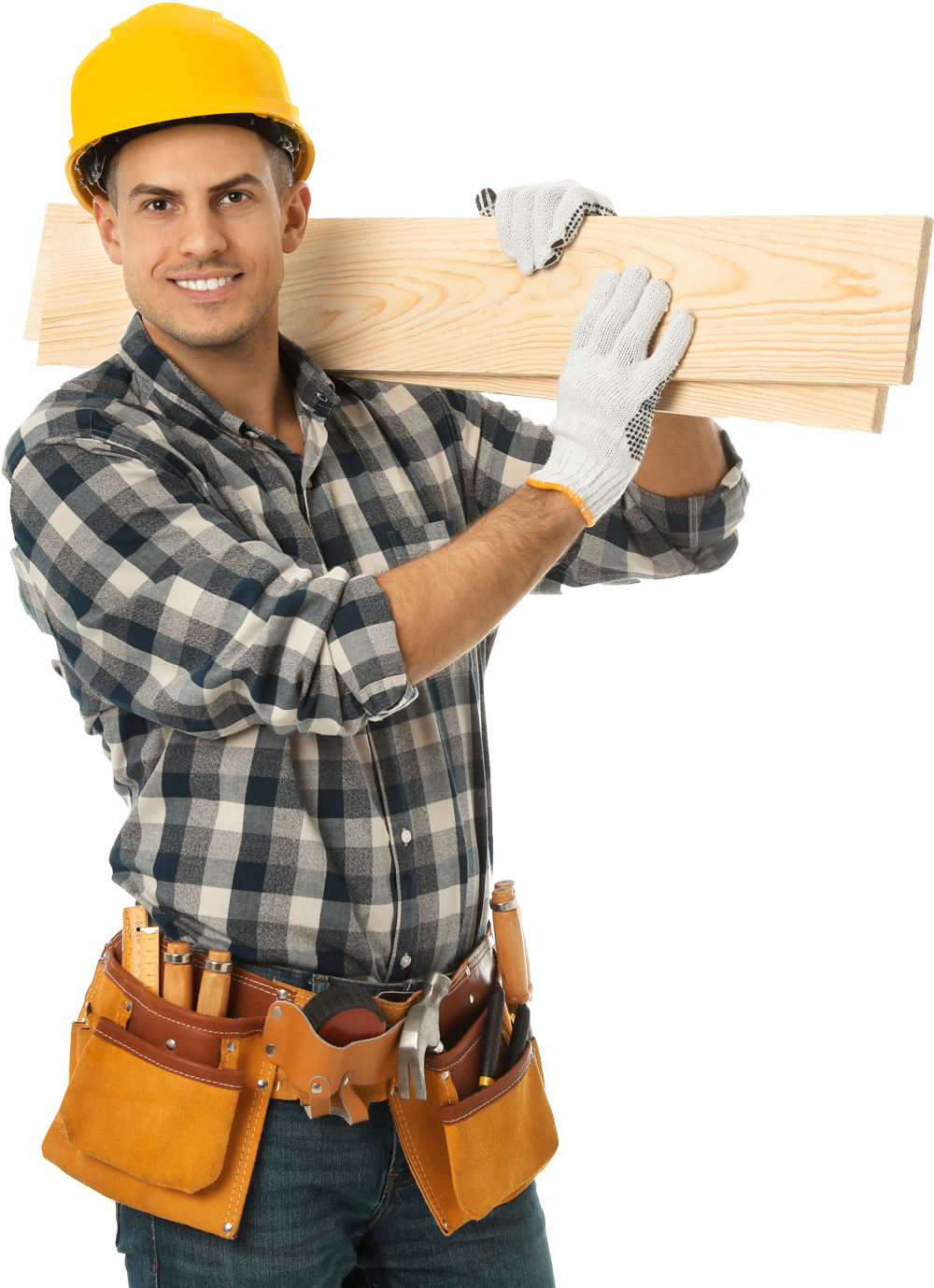 A man wearing a hard hat and gloves is carrying a piece of wood.