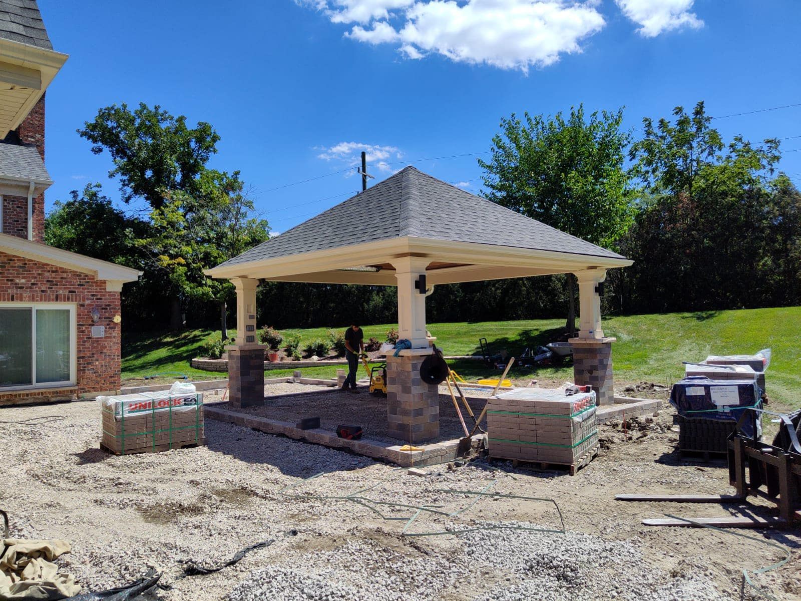 A pavilion is being built in the backyard of a house.