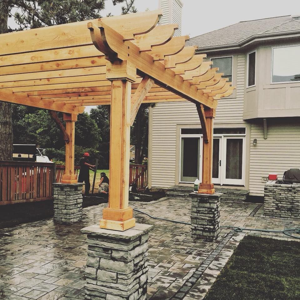 A house with a wooden pergola in front of it