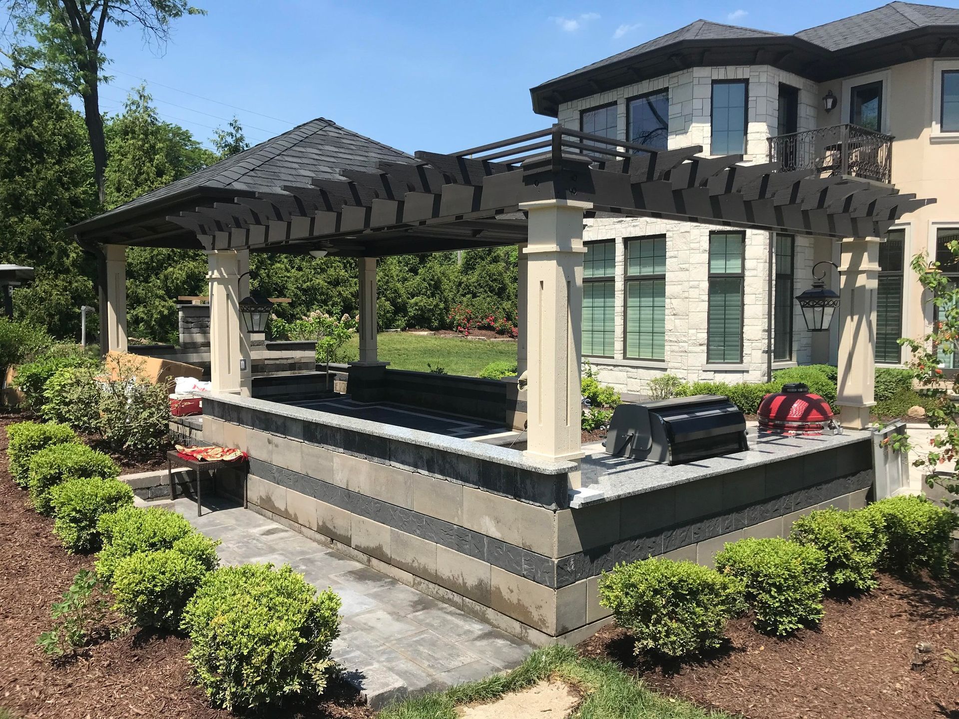 A large house with a pergola in the backyard.