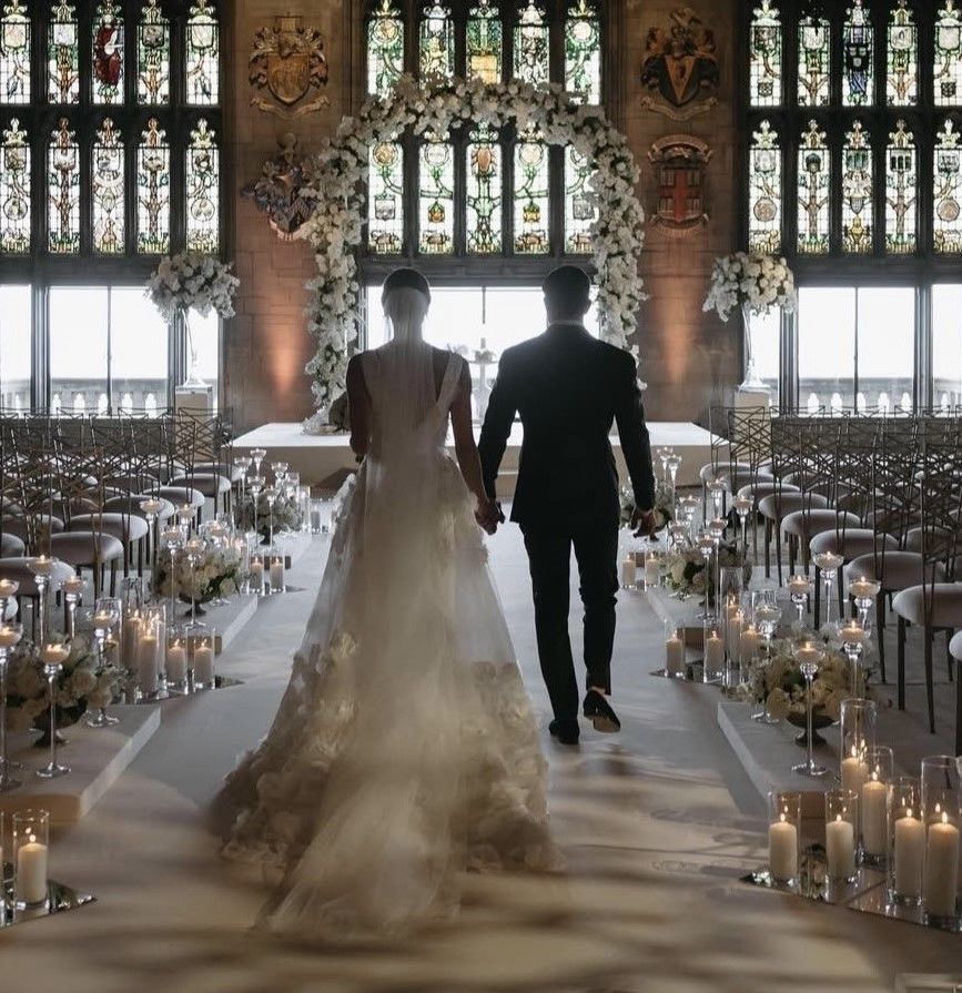 A bride and groom are walking down the aisle at their wedding
