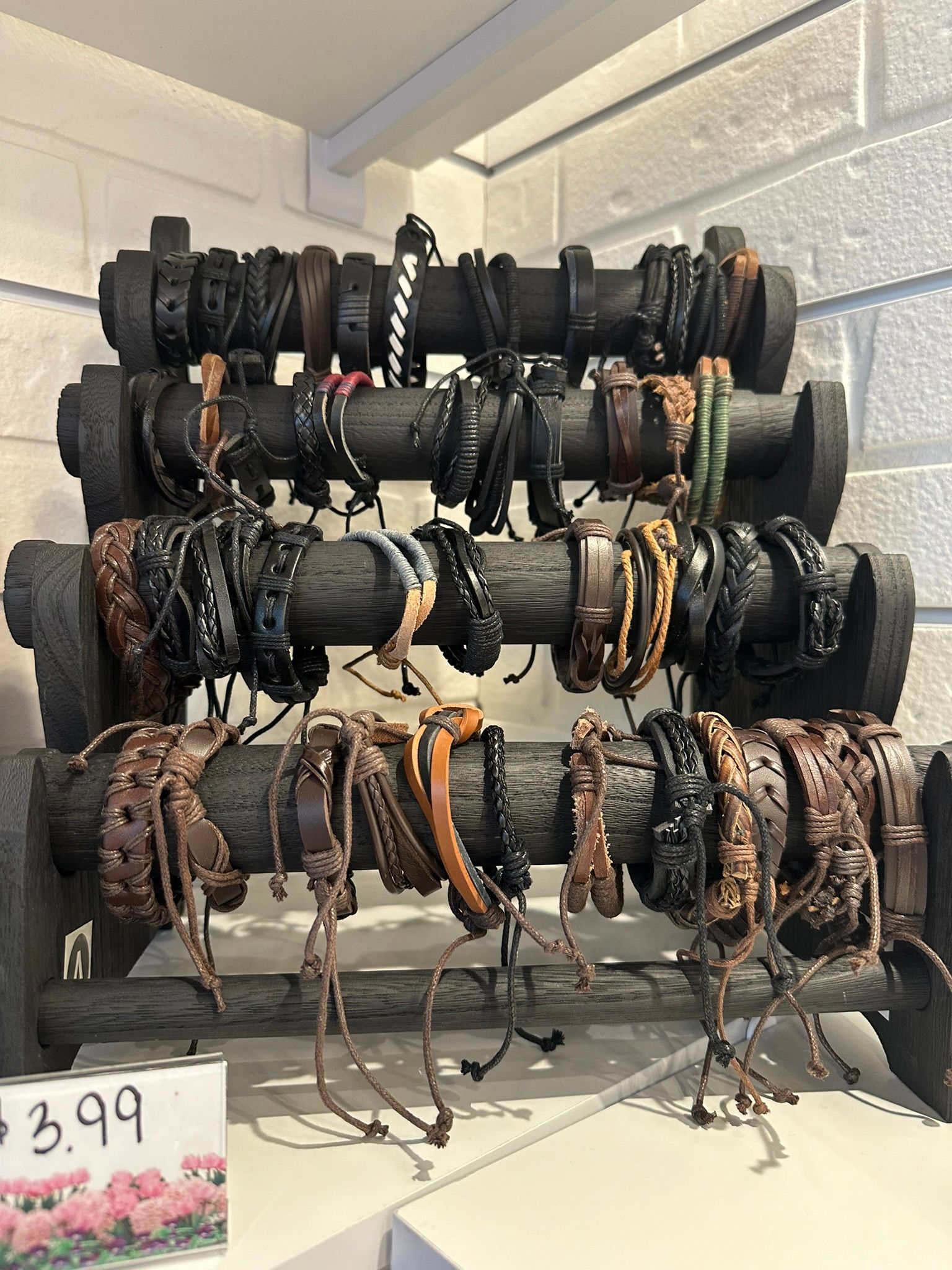 A display of bracelets on a wooden rack in a store. Elite Tanning & Spa