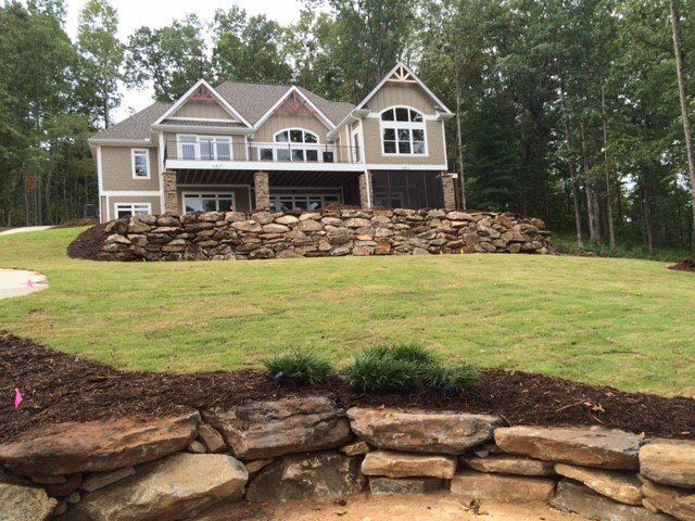 Stone Walls and Grass Field In Front of the House — Seneca, SC — Sheriff Landscaping