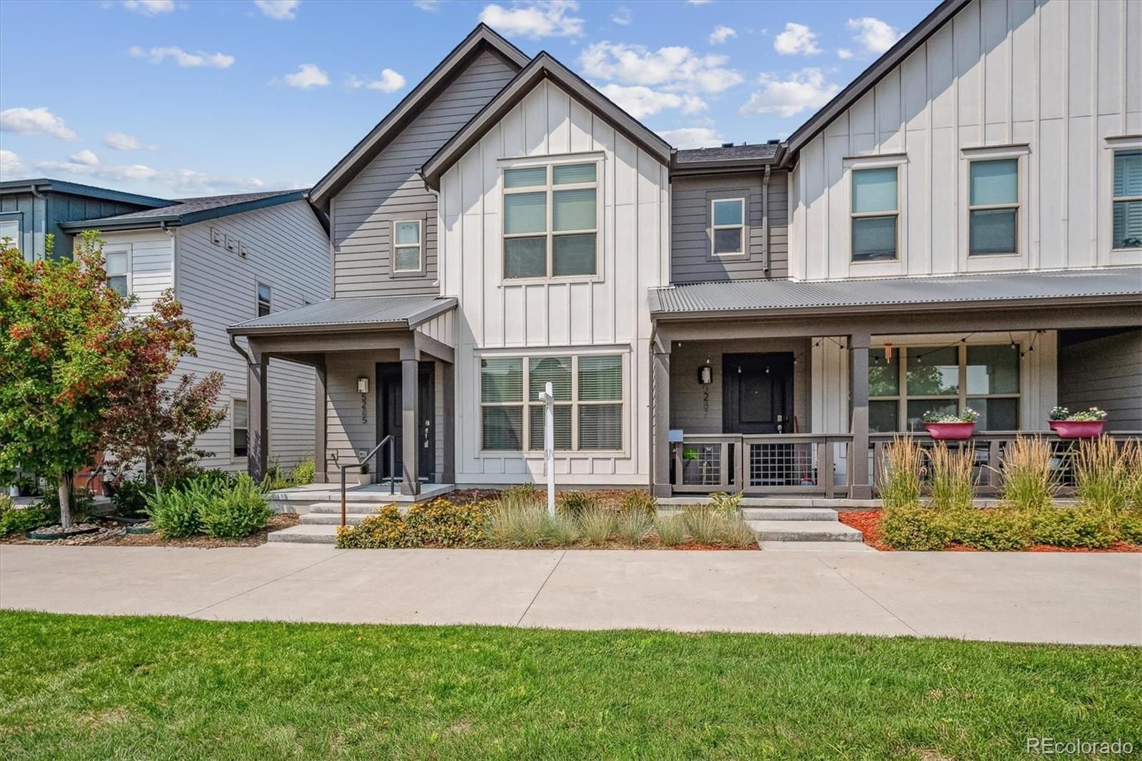 The front of a house with a lot of windows and a porch.