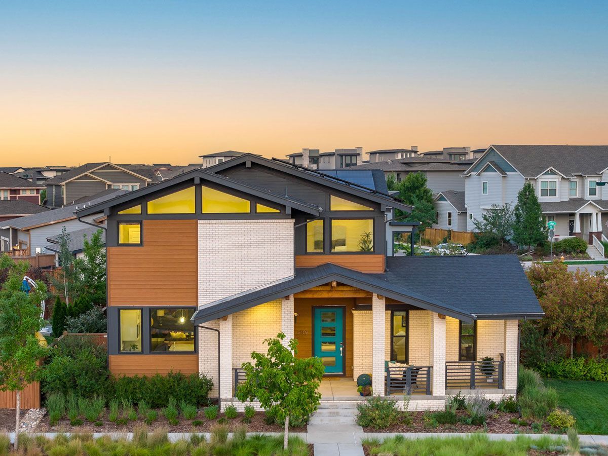 An aerial view of a modern house with a blue door