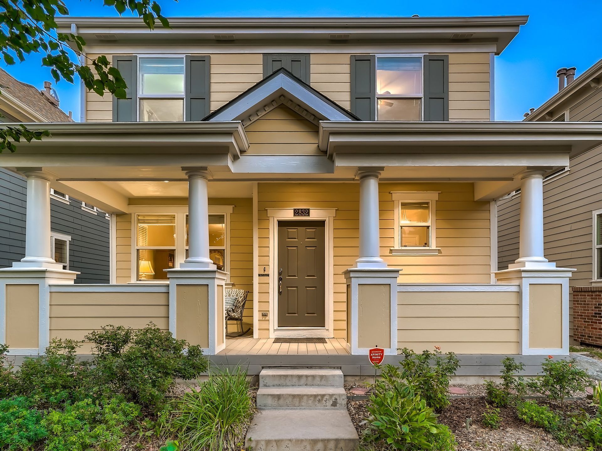 The front of a house with a porch and stairs leading up to it.