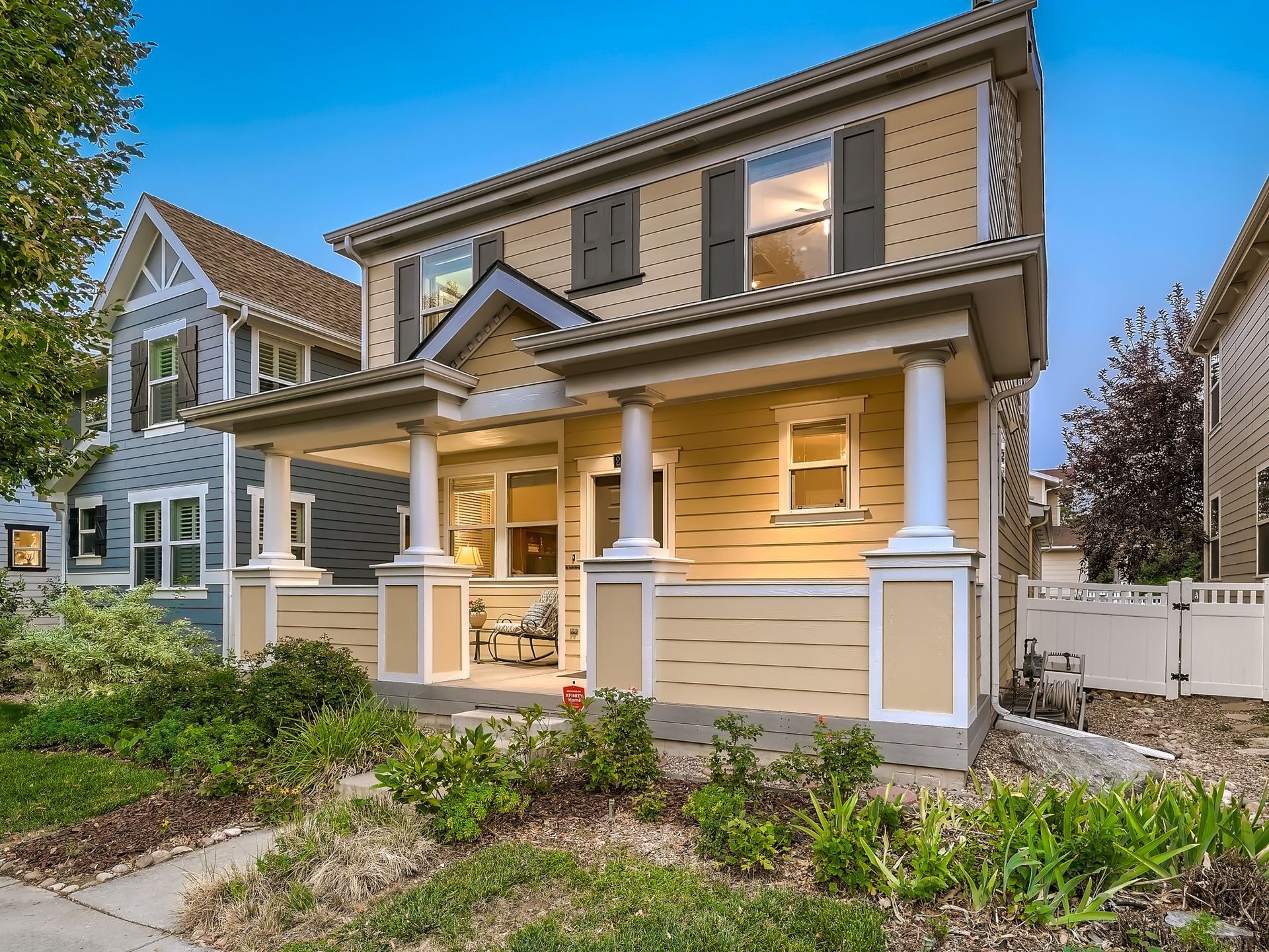 A large house with a porch and columns is for sale.