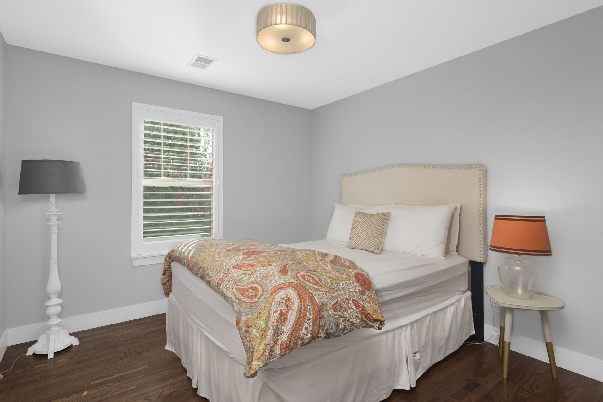 A dining room with a table and chairs and a window.