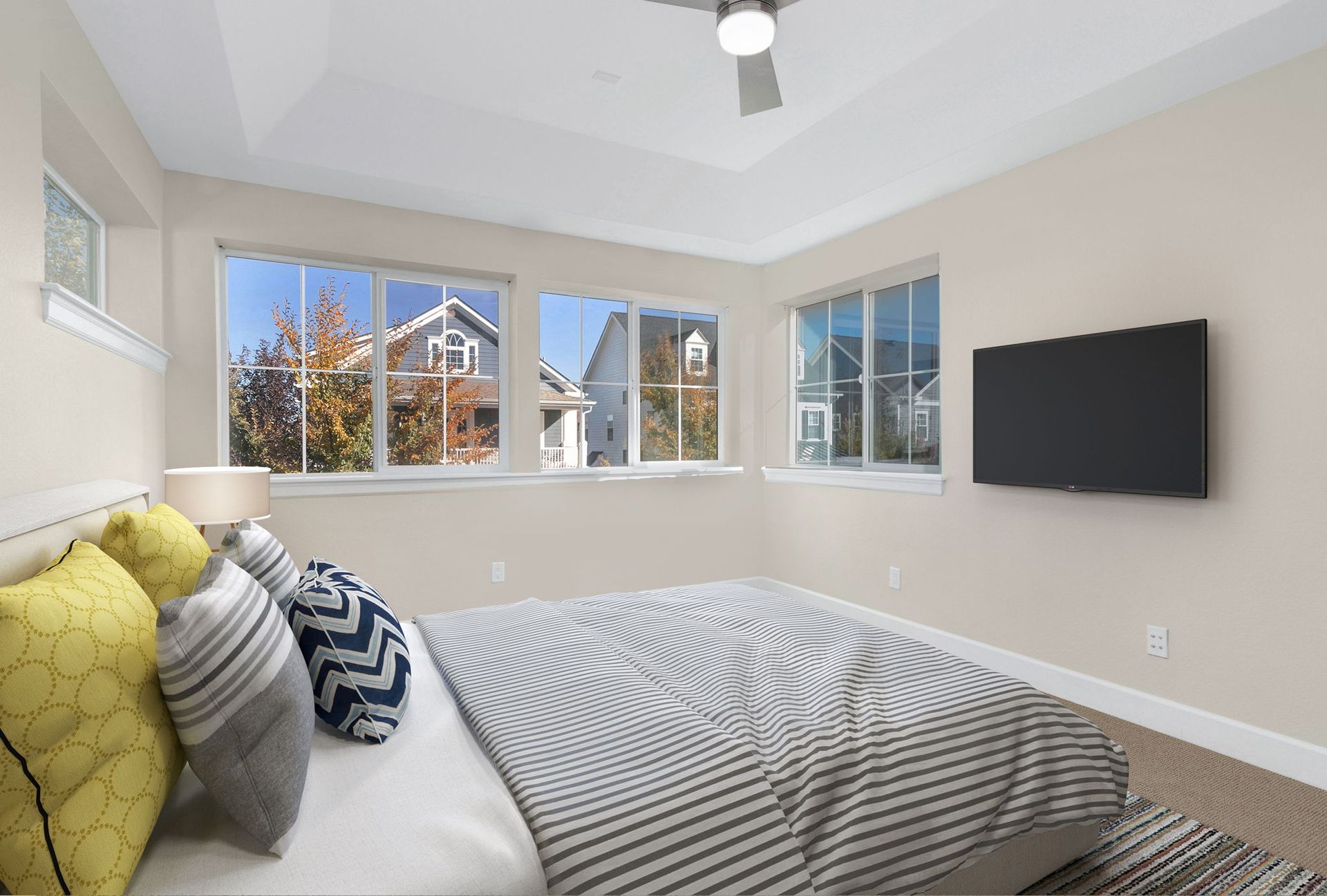 An empty room with hardwood floors and a ceiling fan.