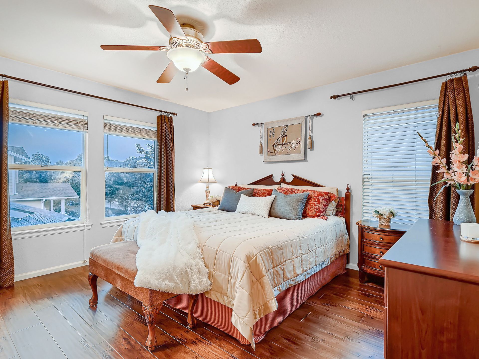 A home office with a desk , chair , and ceiling fan.