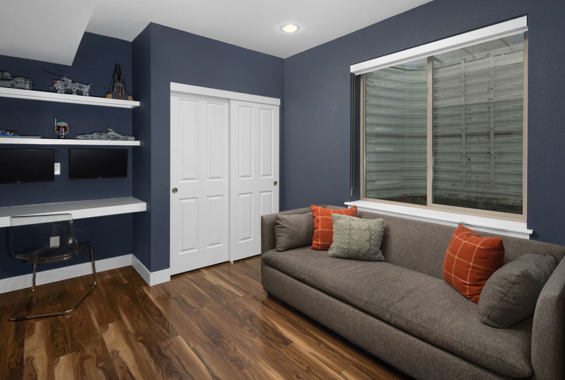 A yellow house with a porch and trees in front of it