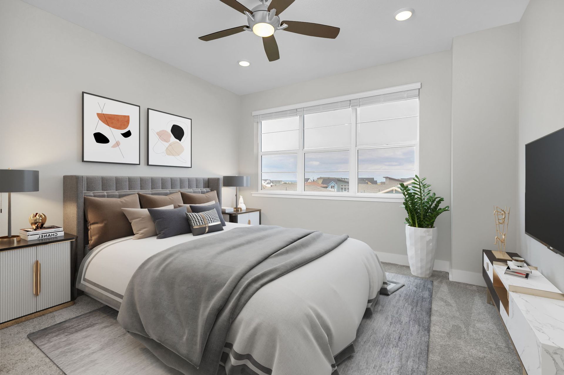 A row of apartment buildings with a lush green lawn in front of them.