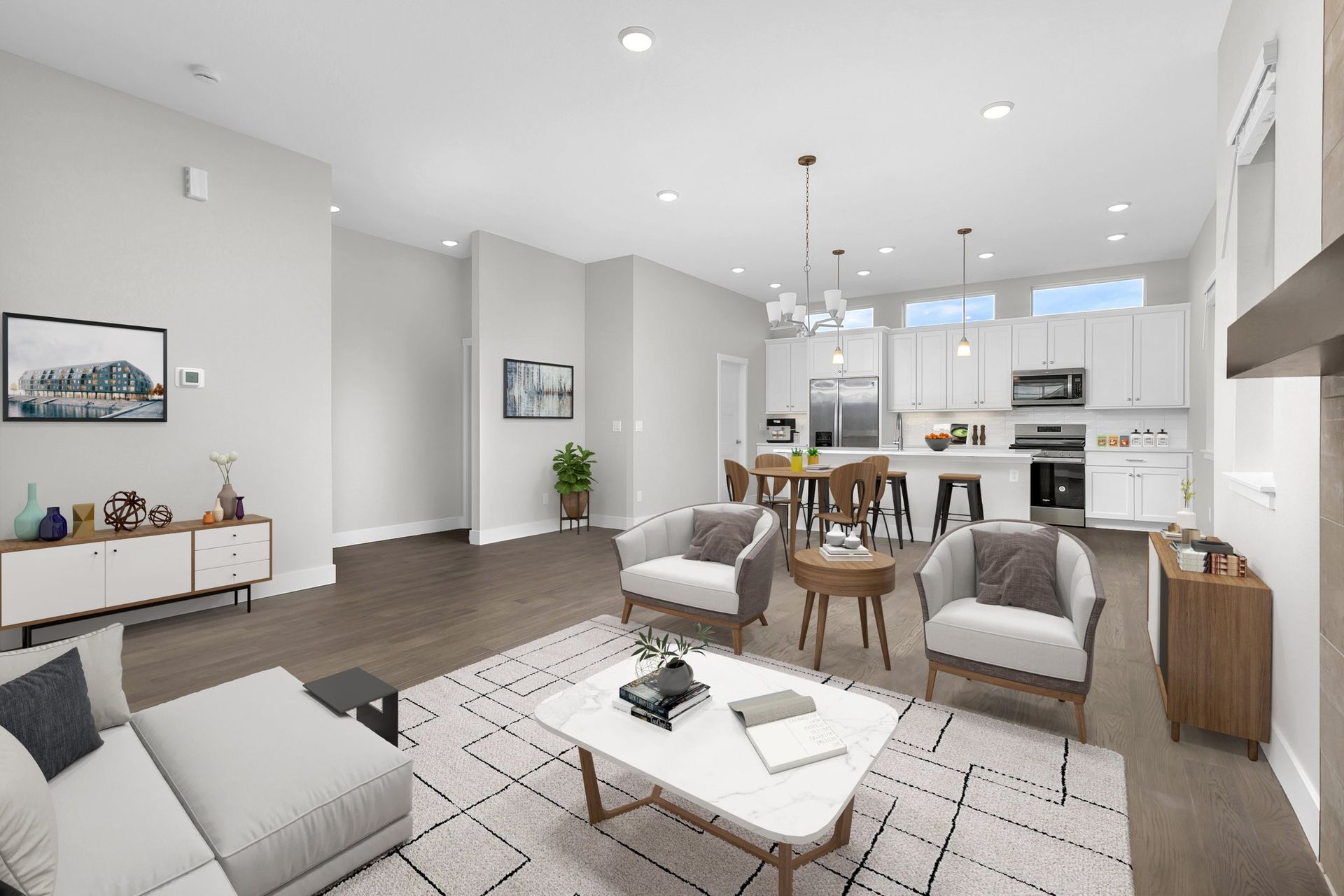 A kitchen with white cabinets , stainless steel appliances , and a large island.