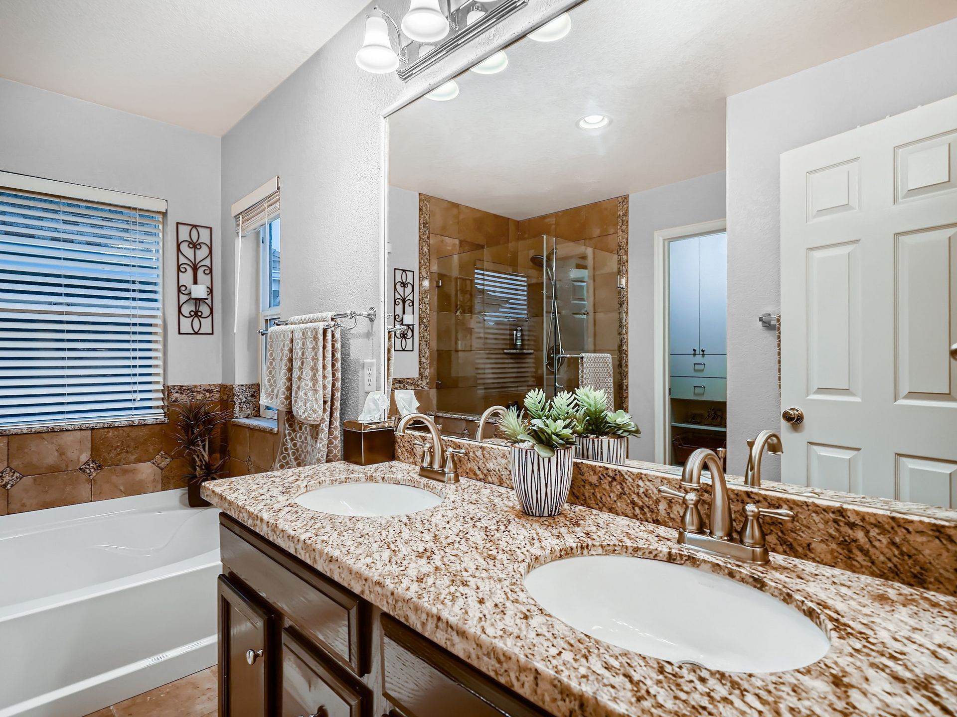 A large house with a porch and columns is for sale.