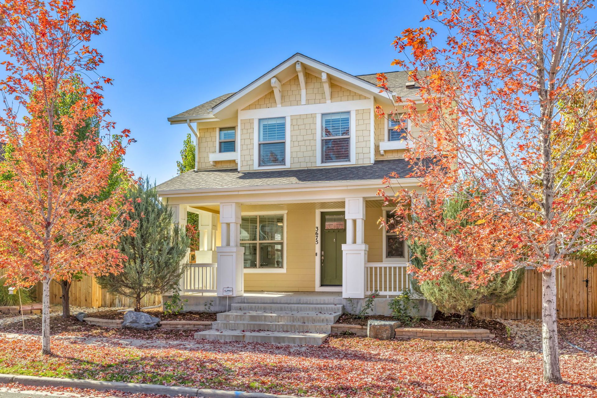 A bedroom with a bed , desk , chair and window.