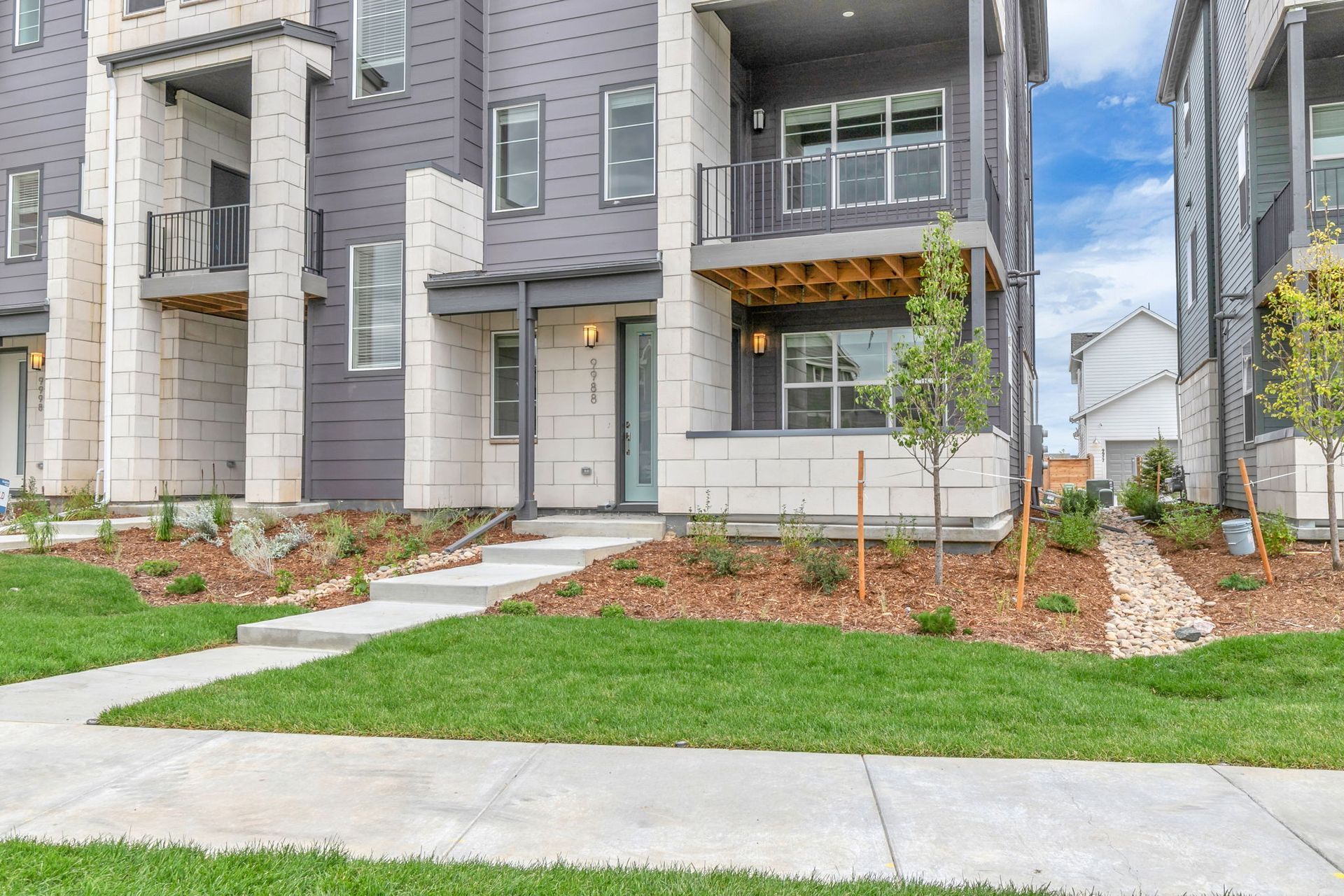 A bedroom with a large bed , ceiling fan , and television.