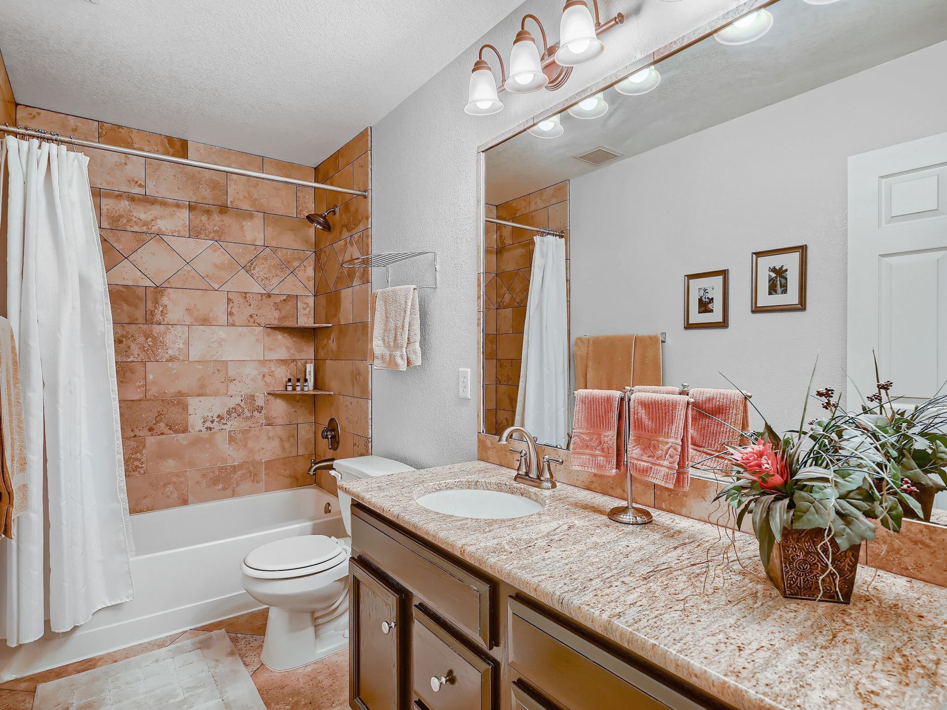 A dining room with a table and chairs and a chandelier.