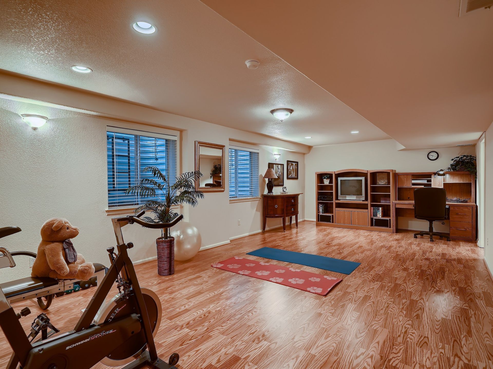 A kitchen with black cabinets , stainless steel appliances , granite counter tops and a wooden island.