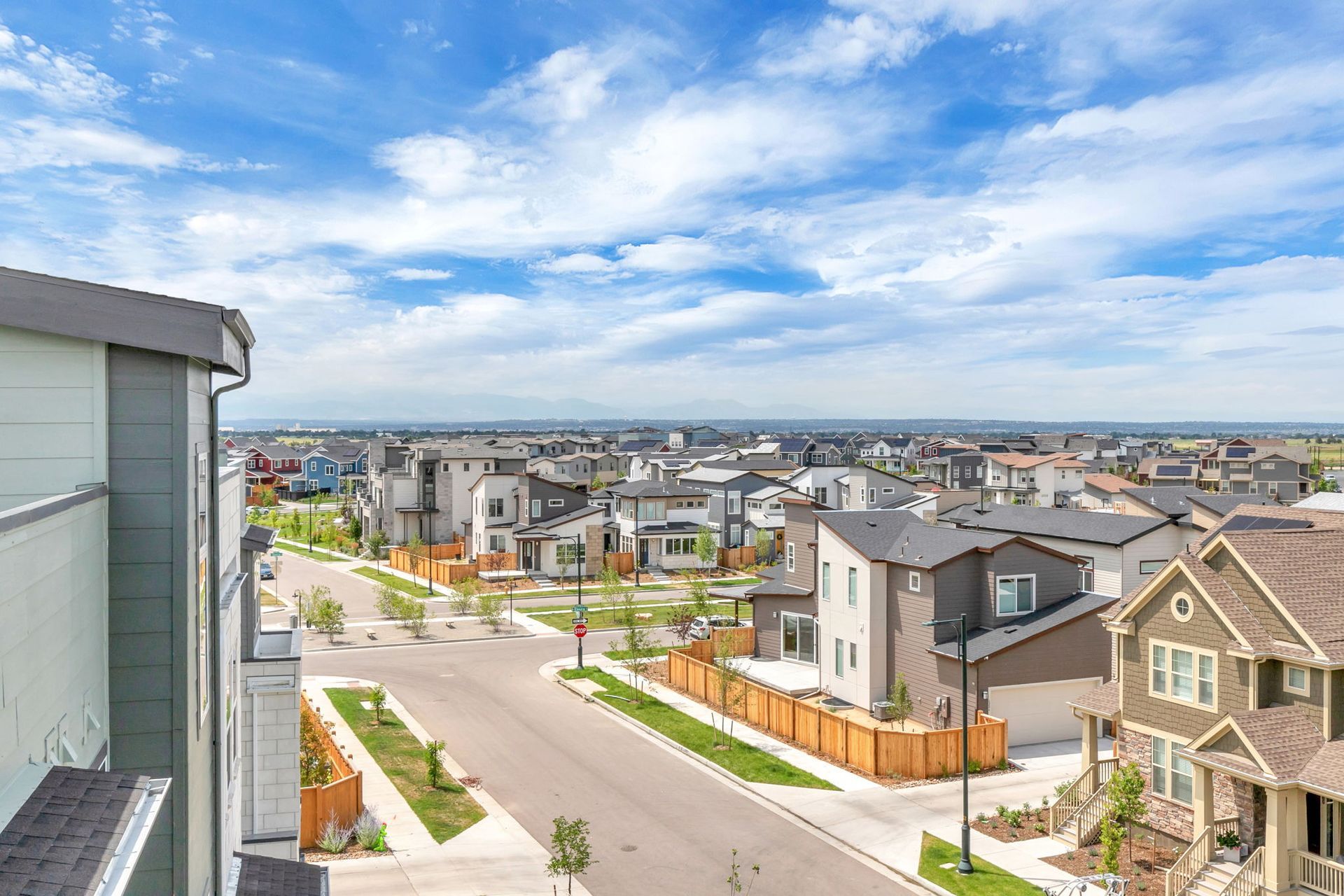 An aerial view of a residential neighborhood with lots of houses and trees.