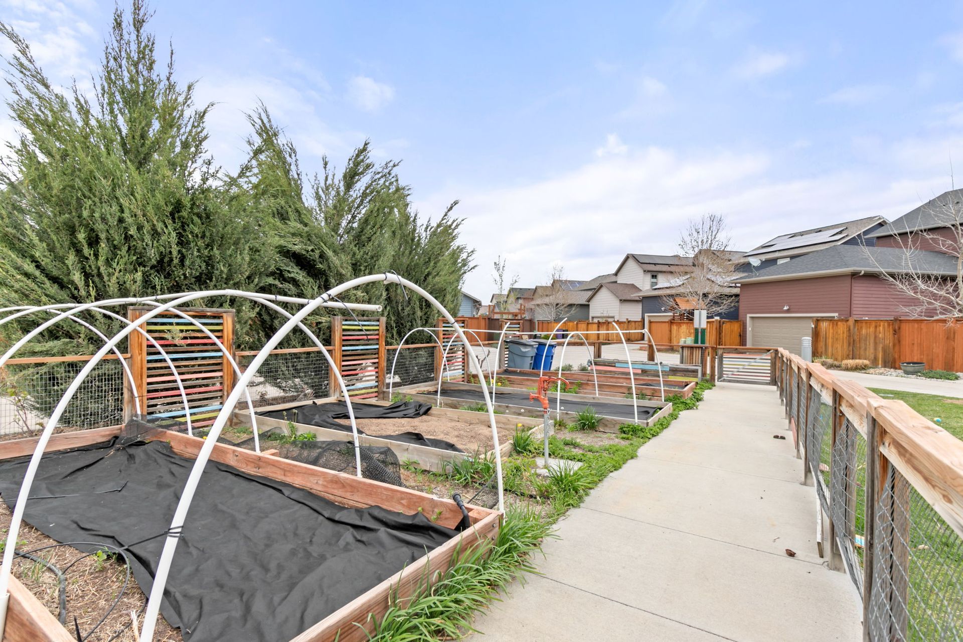 A bedroom with a large bed and a ceiling fan.