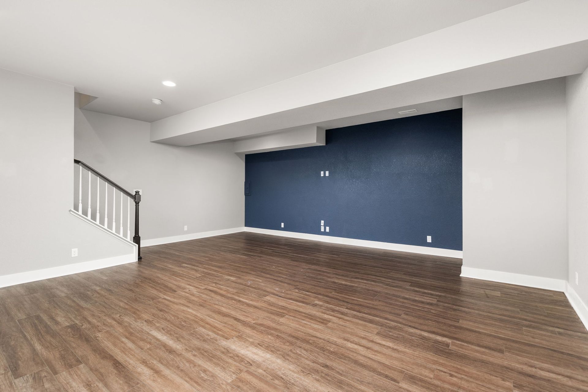 An empty room with blue walls and white doors