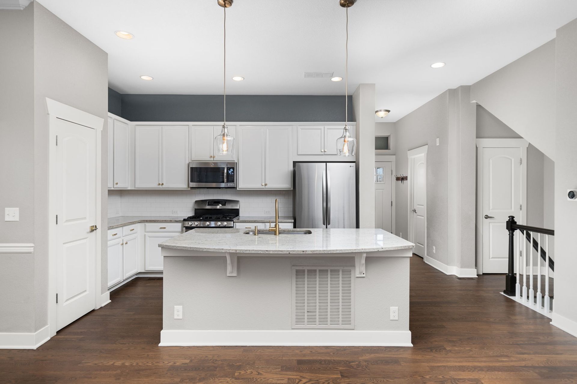 There is a large island in the middle of the kitchen.