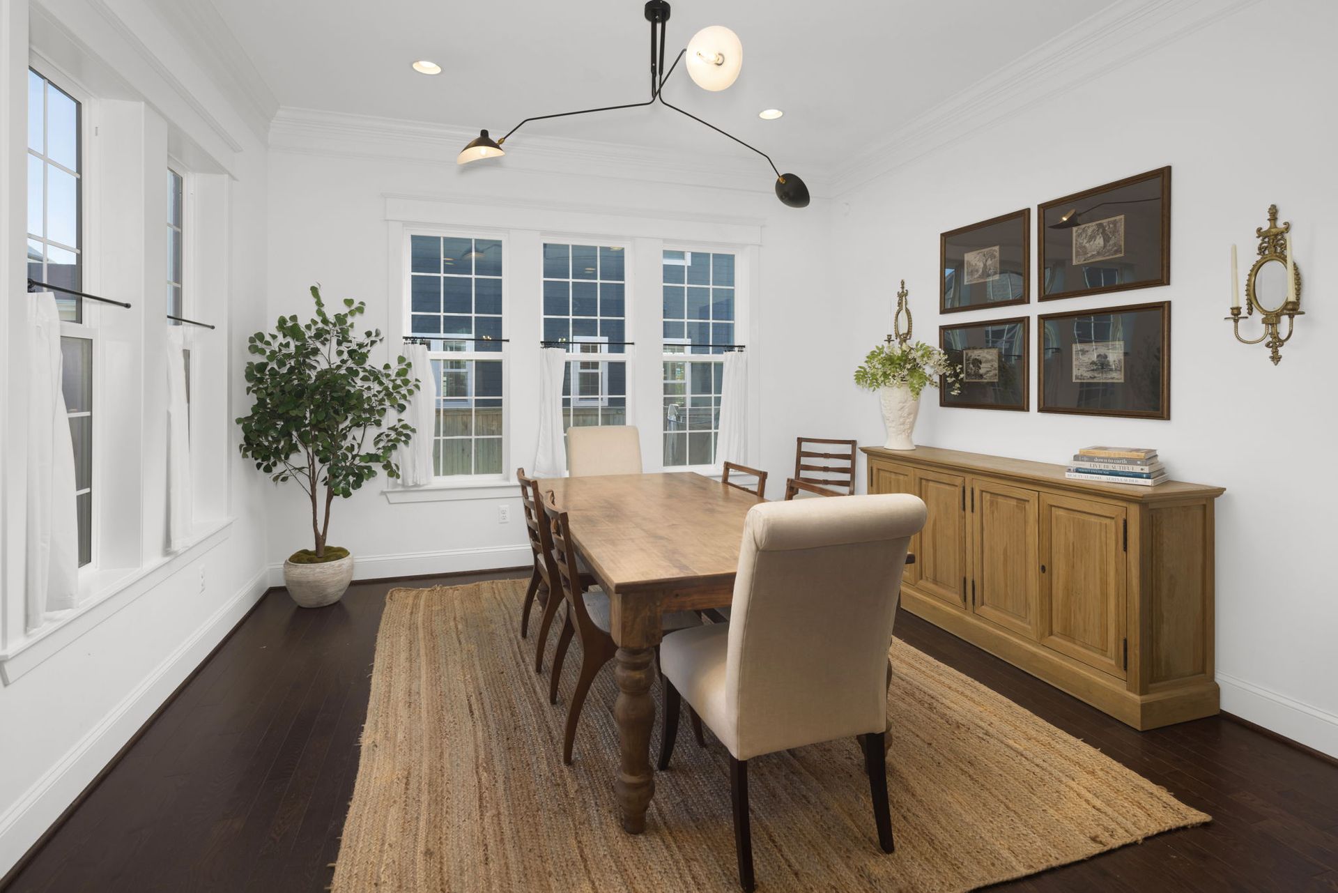 A dining room with a long wooden table and chairs