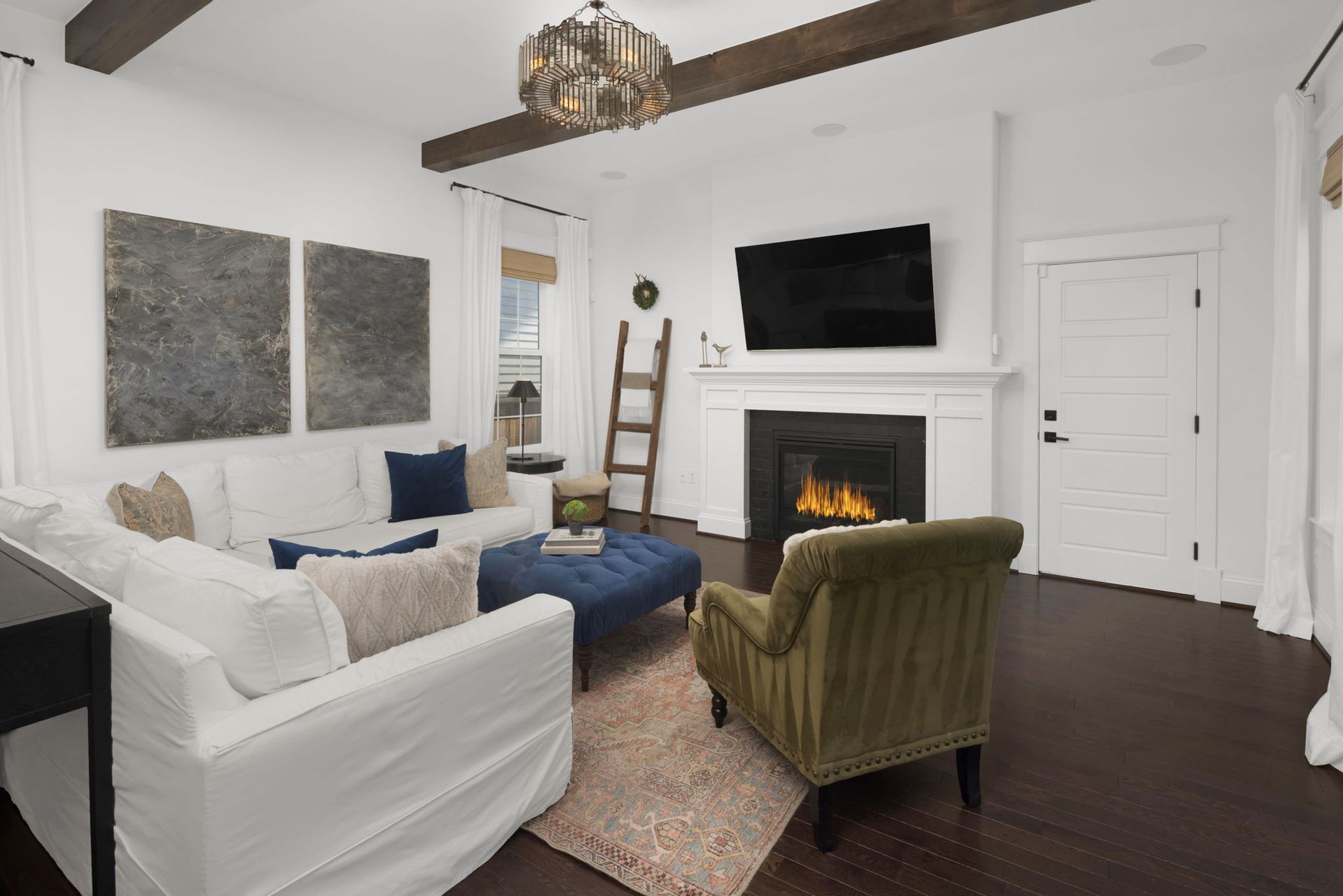 A living room with a fireplace , couch , chair and television.