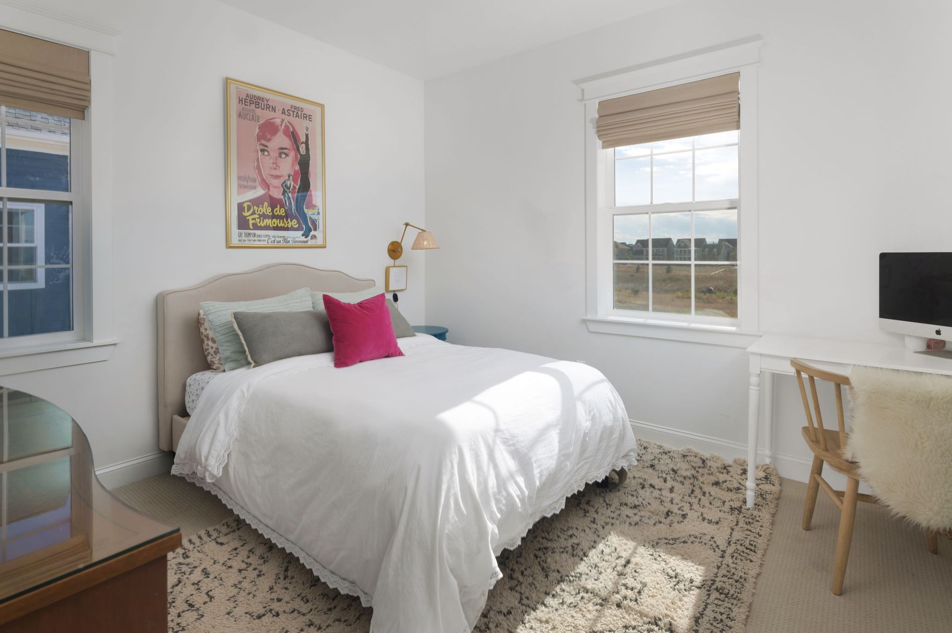 A bedroom with a bed , desk , chair and computer.