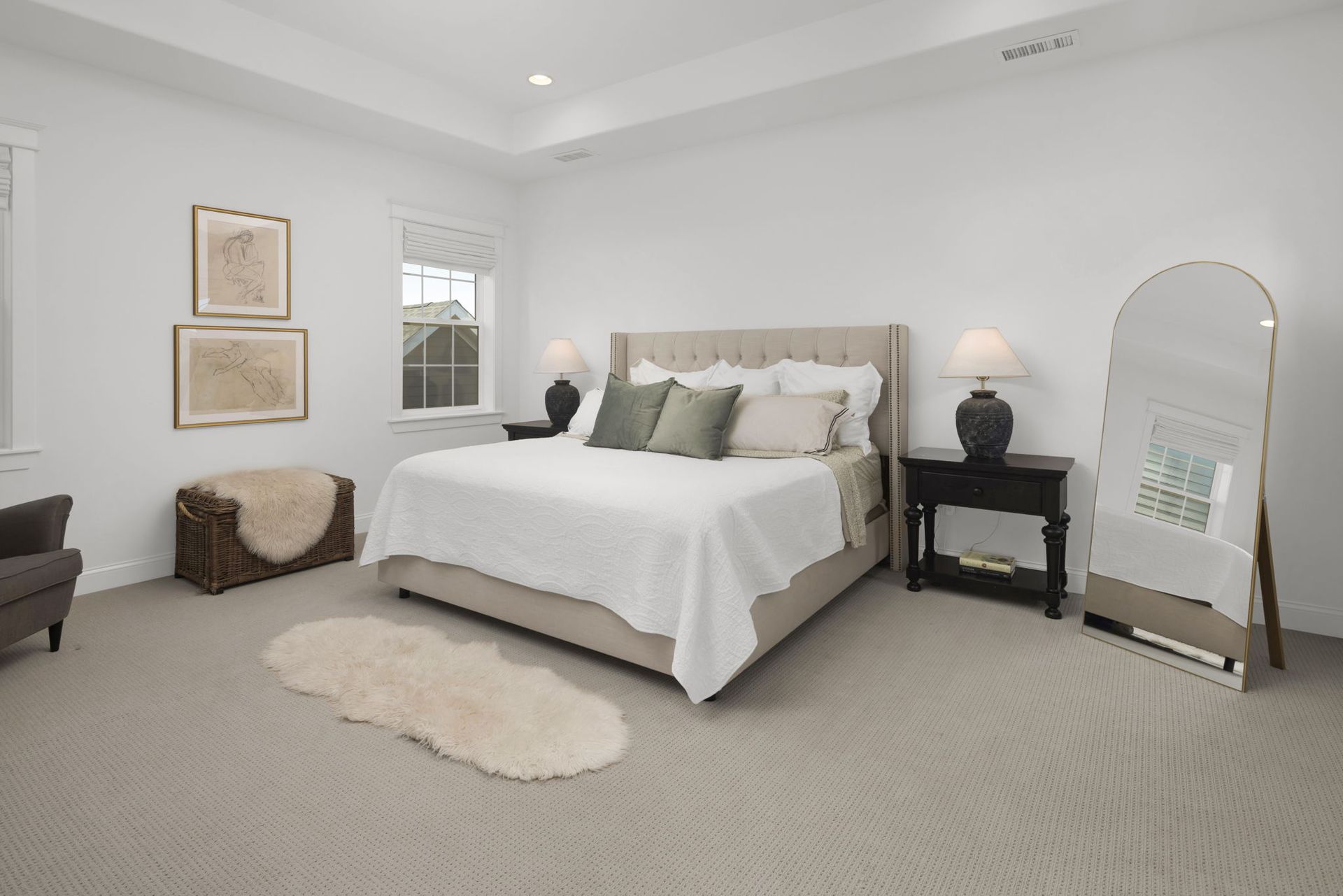 A bedroom with a large bed and a mirror.