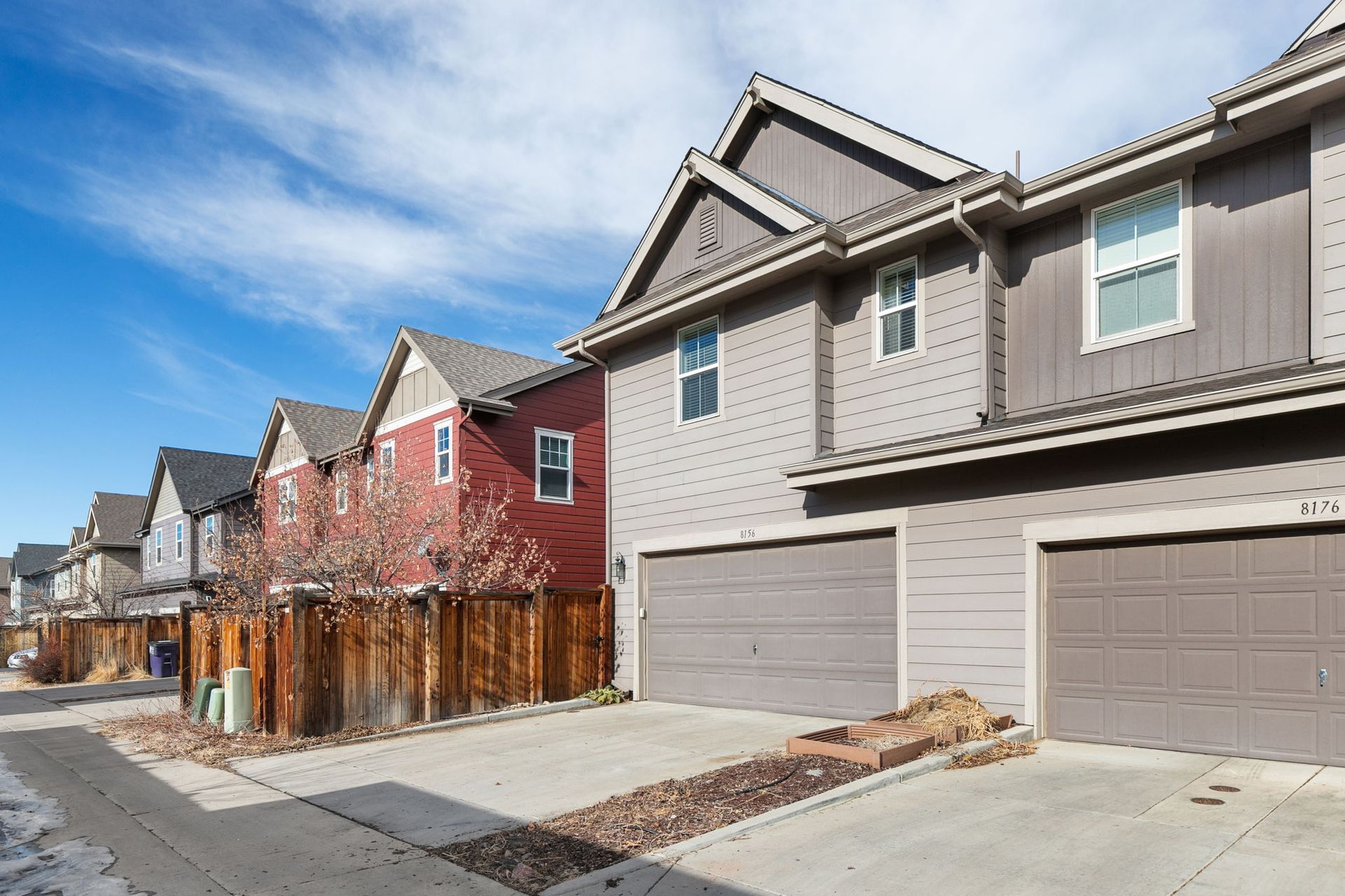 A bedroom with a large bed and a bench.