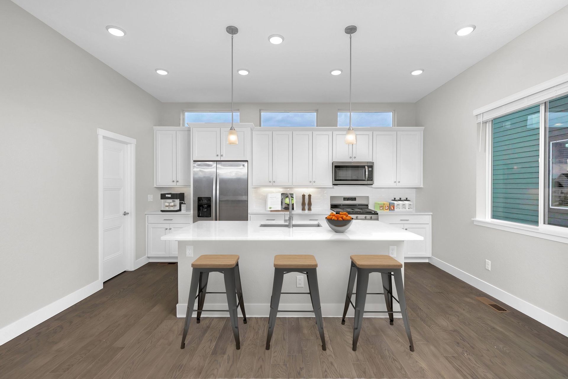 A living room with a couch , chairs , and a coffee table.