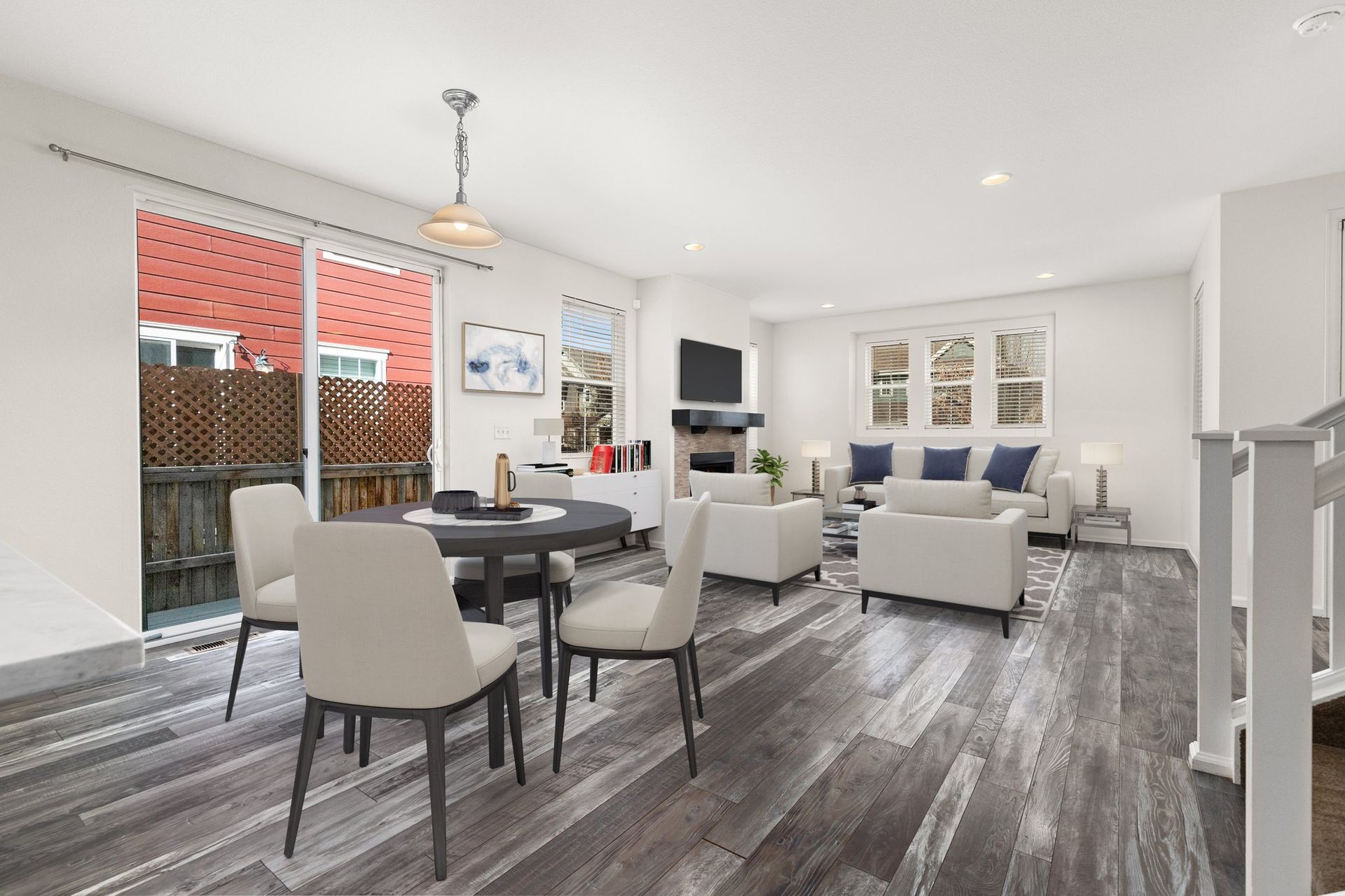 A kitchen with white cabinets , stainless steel appliances , and a large island.