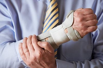 Worker holding injured wrist