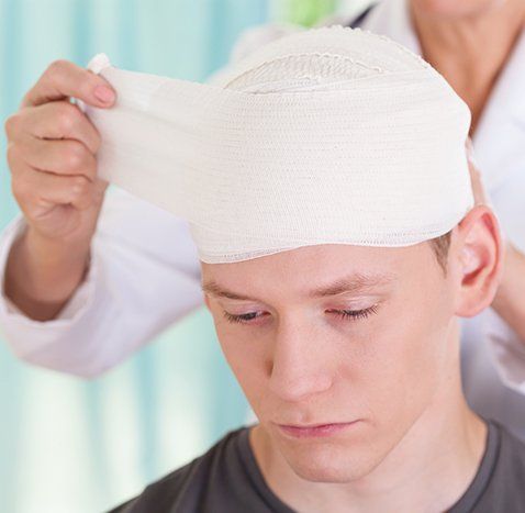 nurse wrapping mans head in bandage