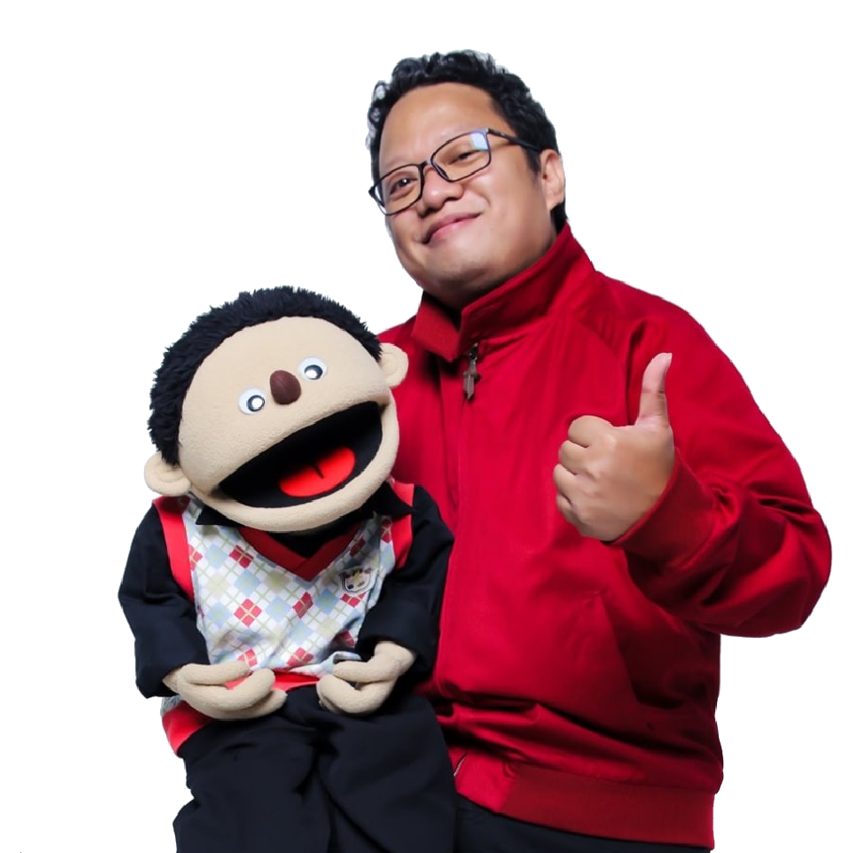 A man in a red jacket is holding a puppet and giving a thumbs up