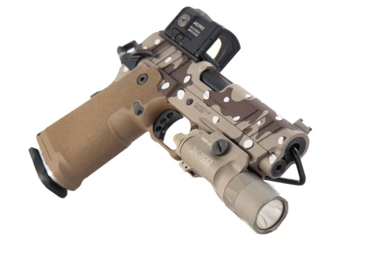 Tan and camo handgun with red dot sight and flashlight.
