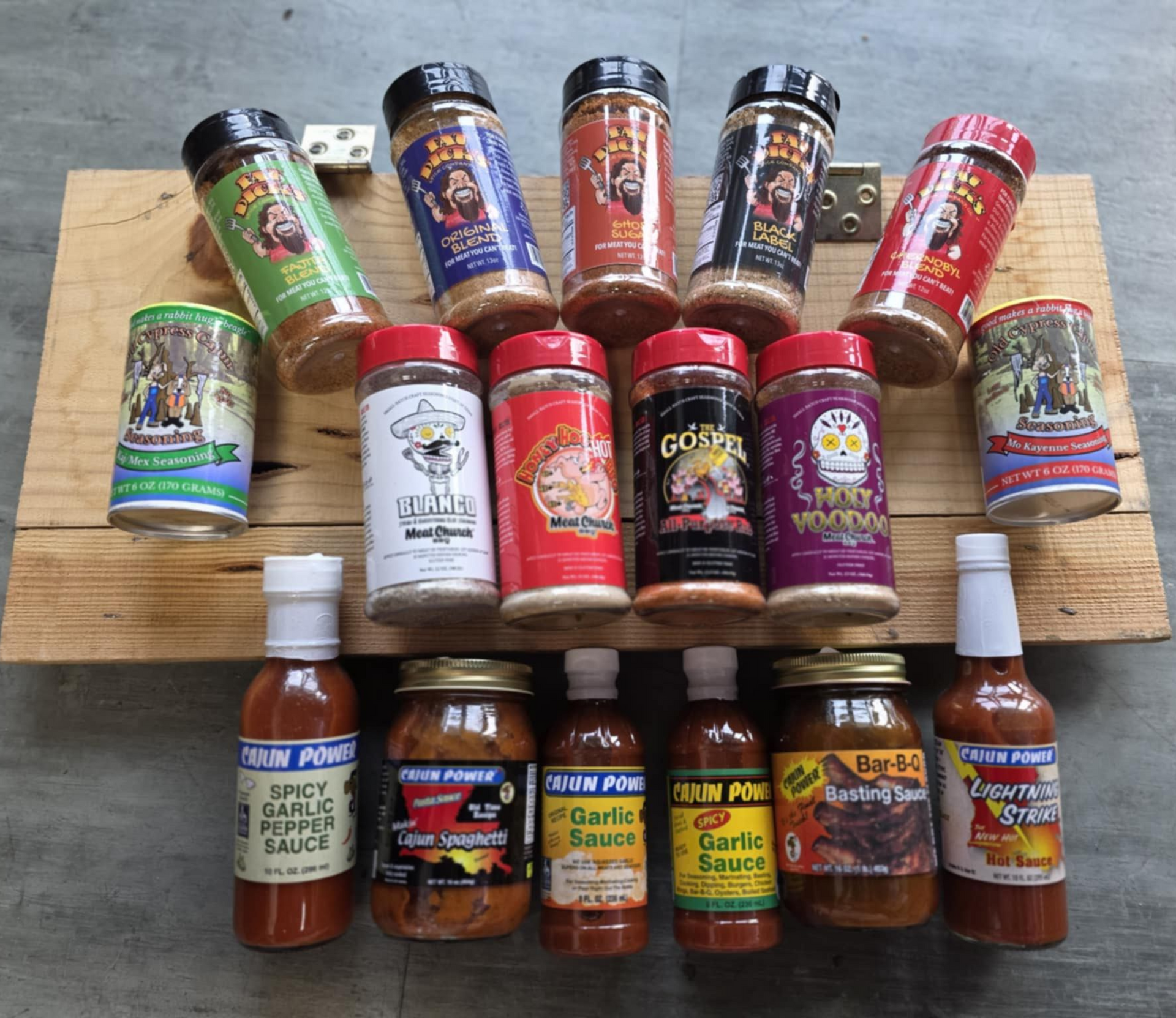 Various spice and sauce bottles on a wooden plank. Labels have colorful cartoon characters.