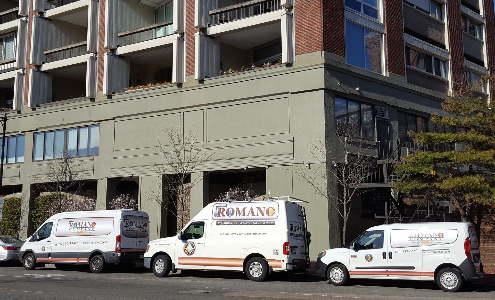 A row of vans parked in front of a building.