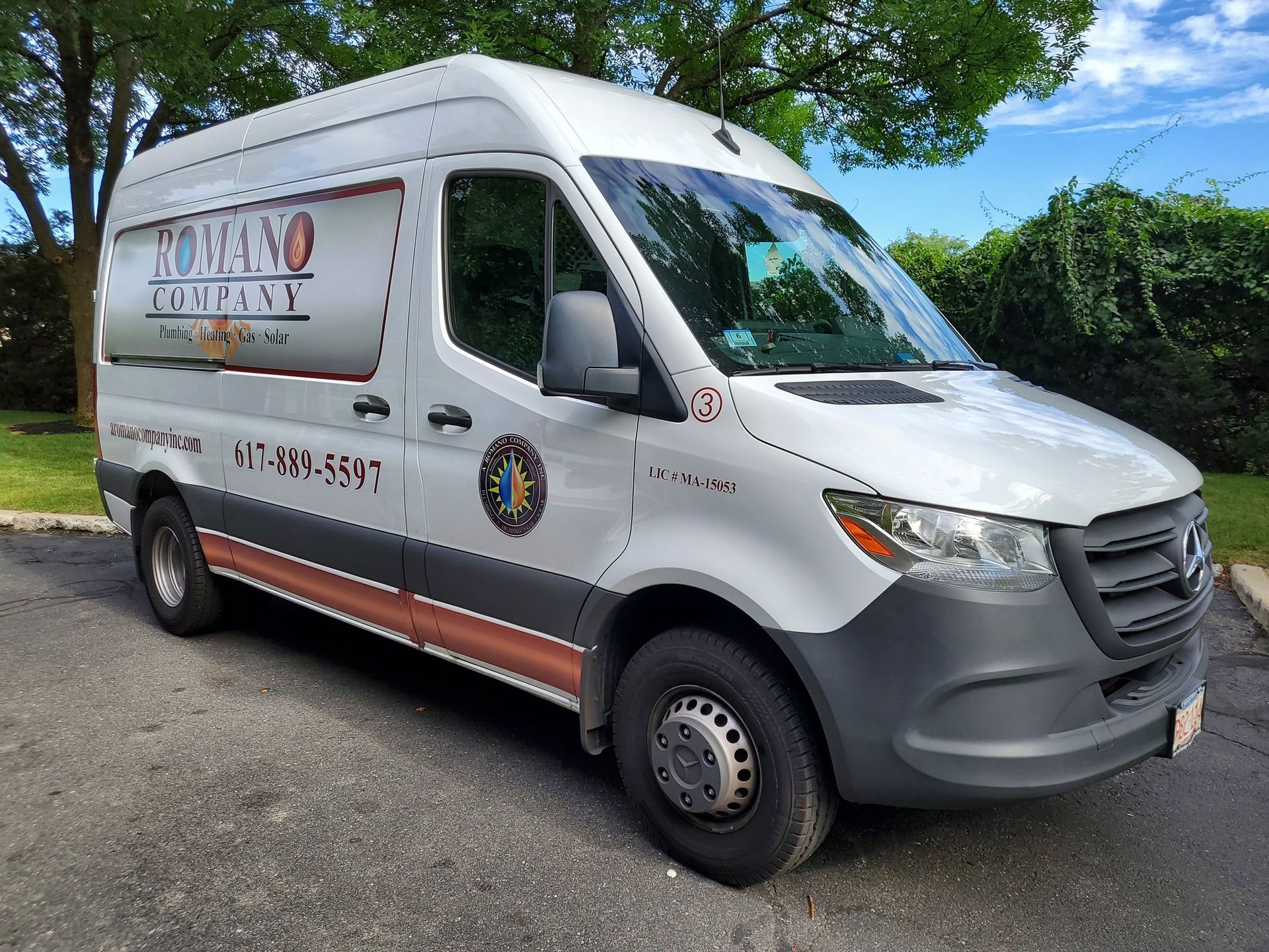 A white van is parked on the side of the road.
