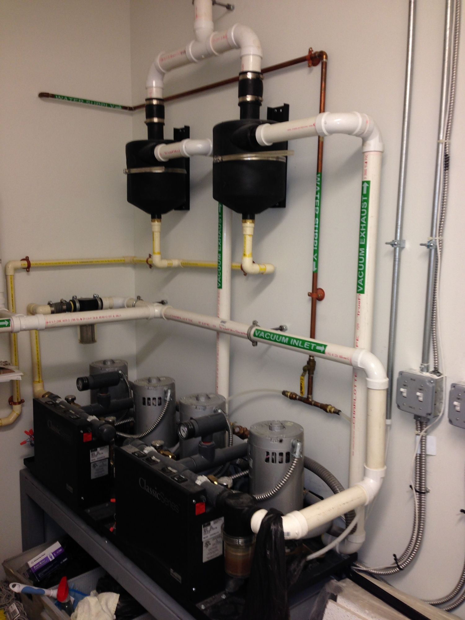 A room with a lot of pipes and a sign that says ' electrical ' on it