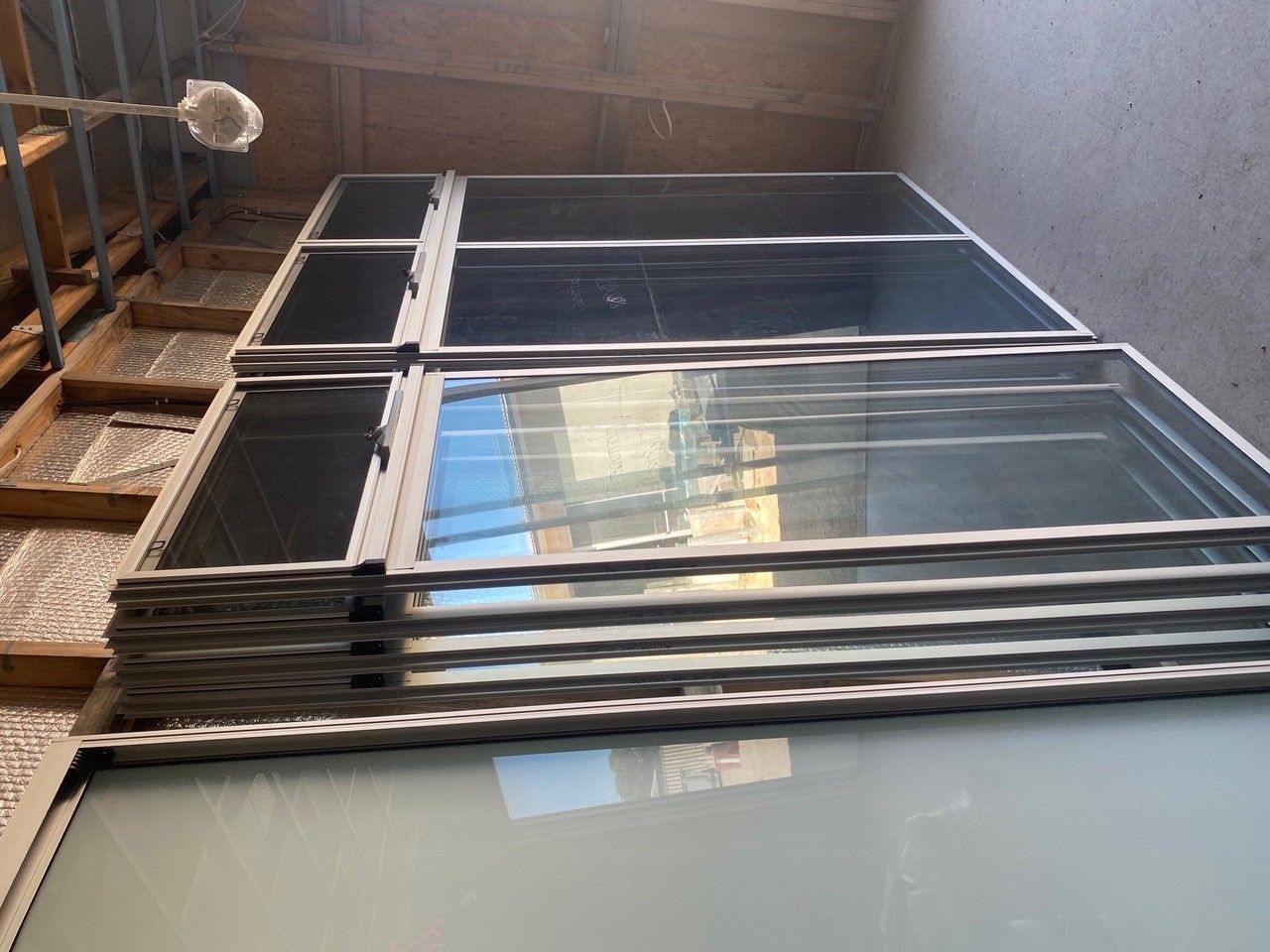 A stack of glass windows sitting on top of each other in a room.