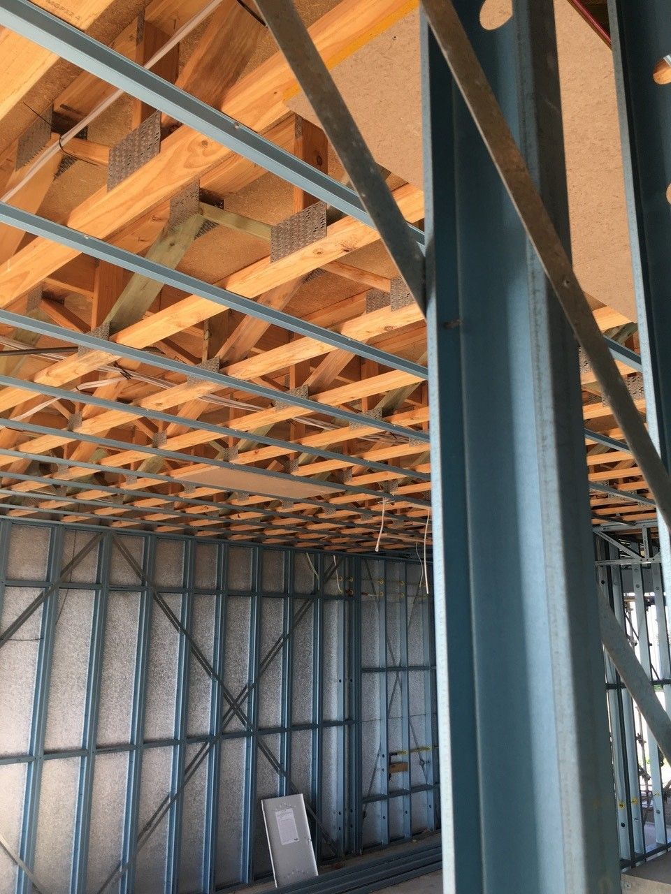The inside of a building under construction with a wooden ceiling