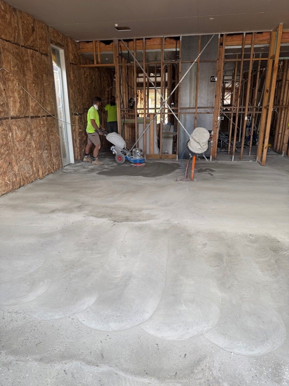 A group of men are working on the floor of a building.