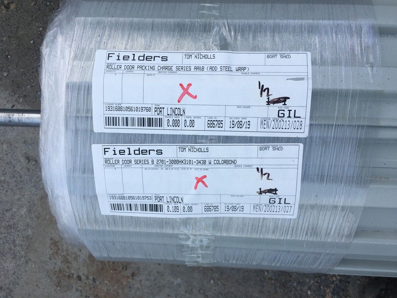 A motor is wrapped in plastic and has labels on it that say fieldere and gil