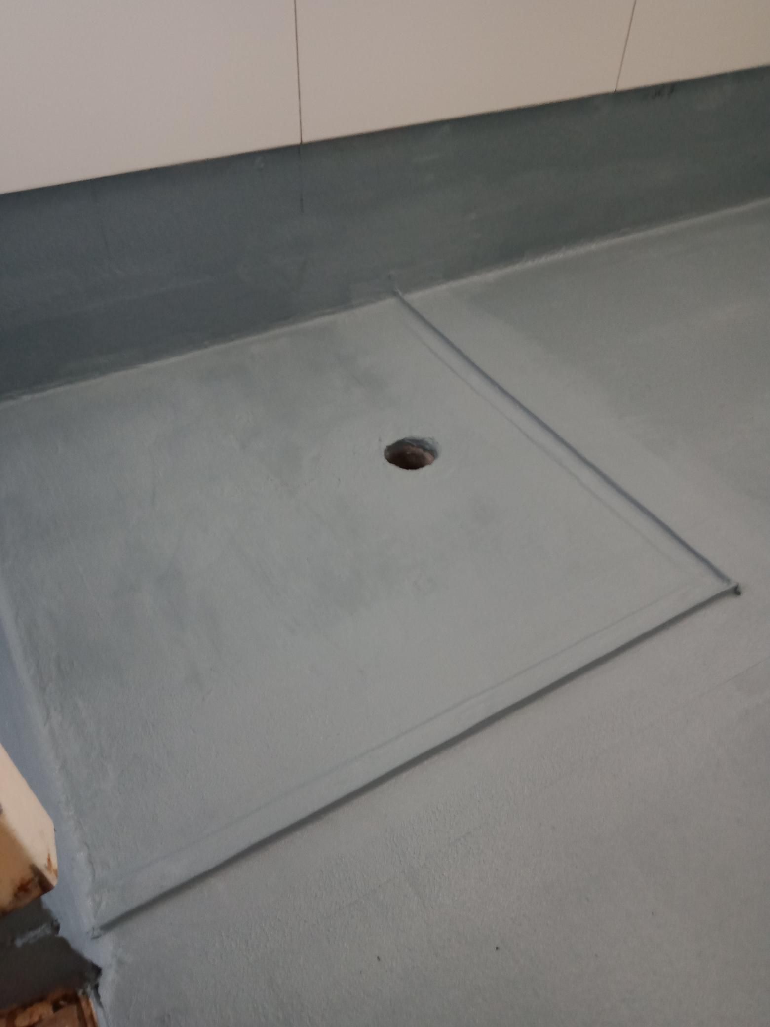 A concrete floor with a hole in the middle of it.