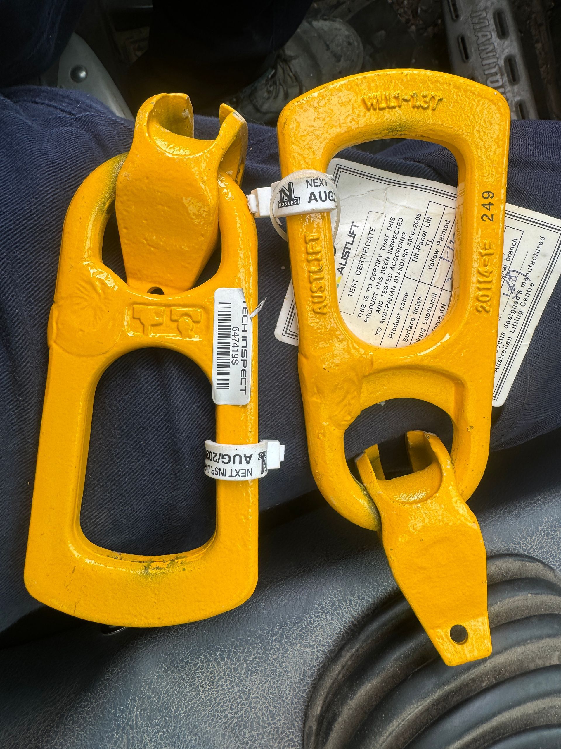 A pair of yellow hooks with a label that says ' eagle ' on it