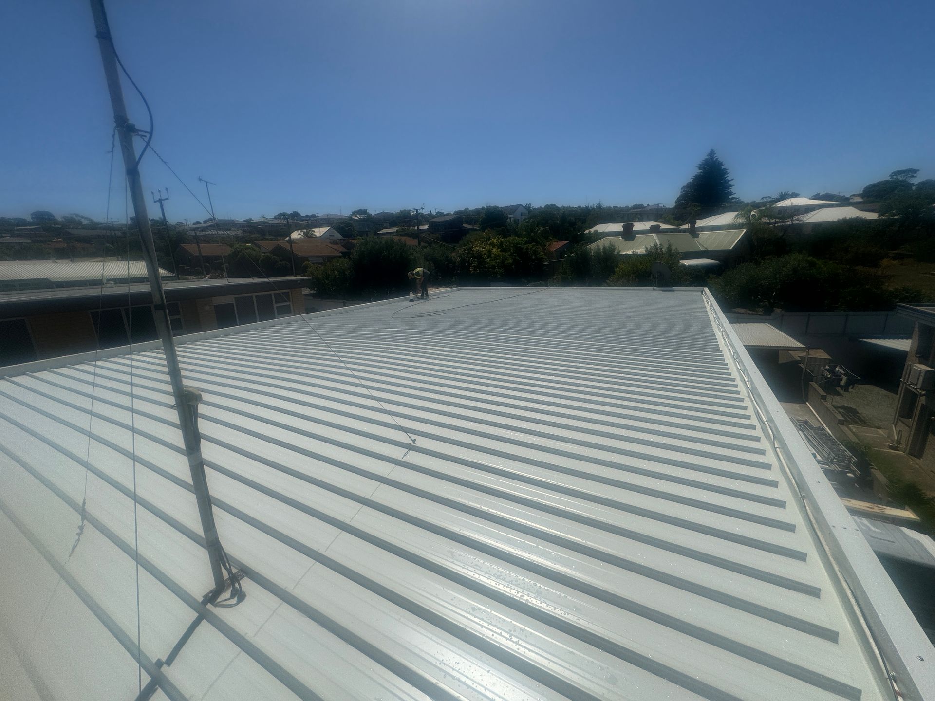 The roof of a building with a satellite dish on it.