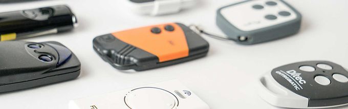 Una mano usa un cacciavite per stringere una vite sul meccanismo di chiusura di una porta, vicino a un portachiavi.